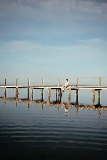 Years Old Prints: A lonely man sitting on the dock early in the morning