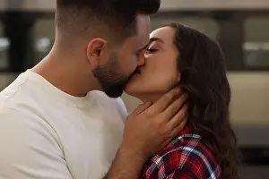 Kissing Prints: Long-distance relationship. Beautiful couple kissing near train outdoors