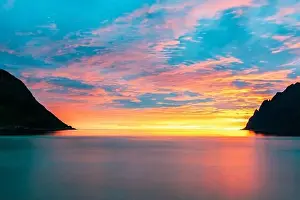 Northern Norway Prints: Long exposure of sea colored by the warm lights of midnight sun