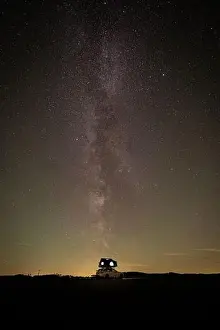 Top Road Prints: Long exposure view of the Milky Way on field with car rooftop tent