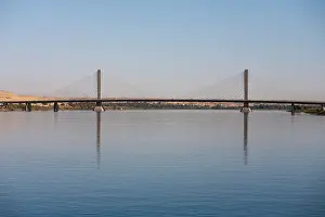 Suspension Prints: Long shot of the Aswan suspension bridge resembling a flat boat with two sails spanning the river Nile
