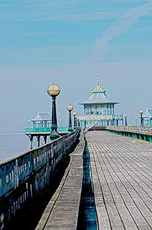 Gazebo Prints: A long wooden pier stretches out into the water