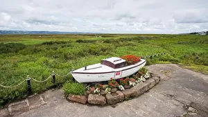Pool Prints: Looking down on an old boat on the shore of Parkgate down the Dee Estuary in Cheshire seen in September 2023