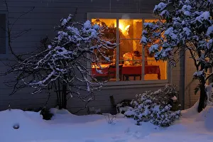 Presents Prints: looking into window of cozy home snowy night lights glowing from window