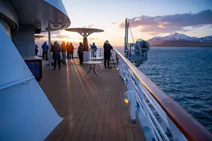 Urban Skyline Prints: Lots of tourist looking at the sunset above the sea at AIDA Bella cruise ship