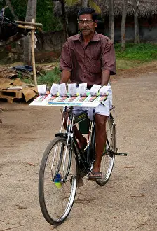 Moves Prints: Lottery ticket seller riding bicycle scene from Kerala
