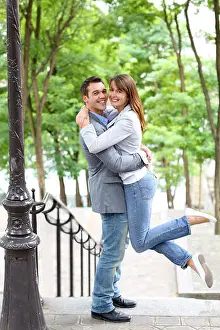 Kissing Prints: In love couple embracing each other in public stairs