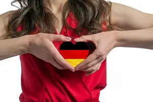 Heart Shape Prints: Love Germany. The woman holds a heart in the form of the flag of Germany on her chest