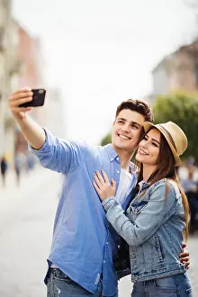 Spring Street Prints: Lovely young tourist couple taking selfie phone on phone for memory spending time together at summer vocation