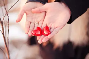 Heterosexual Prints: Lovers couple are holding pair of hearts in their hands as a symbol of love