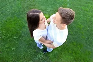Loving couple on green grass background