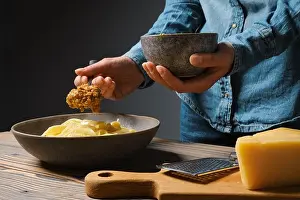 Dressing Prints: Low key photo of unrecognizable woman serve vegetable sauce in plate with pasta