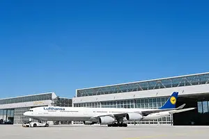 Lufthansa Airbus A340 with push-back truck in front of maintenance hangar, Hangar, Munich, Upper Bavaria, Germany
