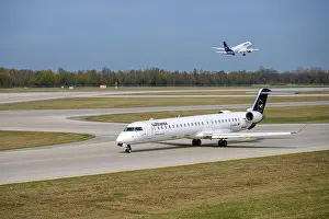 Taxiing Prints: Lufthansa CityLine Mitsubishi CRJ-900LR With The Aircraft Registration D-ACNA Is Taxiing For Take Off On The Northern
