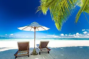 Luxury beach resort, beach loungers near the sea with white sand over sea Tropical island background, summer vacation concept, holiday and tourism