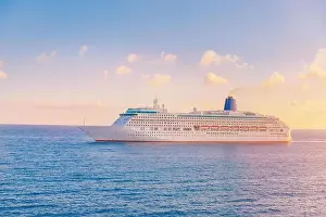 Liner Prints: Luxury cruise ship leaves port sunset in blue sea with clouds