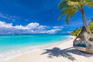 Luxury tropical beach background as summer landscape with beach swing or hammock and white sand and calm sea for beach banner. Exotic travel vacation