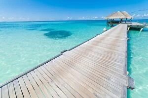 Images Dated 12th December 2015: Luxury over water bungalows in tropical sea under blue sky. Tranquil vacation background