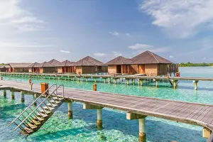 Maldives Islands Prints: Luxury over water villas in Maldives, wooden jetty and blue lagoon