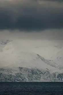 Brim Prints: Lyngen Alps mountains under thick grey clouds in the arctic, northern Norway