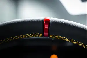 Intimate Prints: Macro of steering wheel with red center marker and yellow stitching