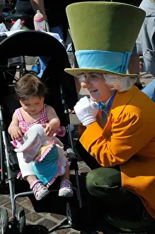 Disney Prints: The Mad Hatter amuses a child at Anaheim Disneyland