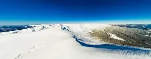Forest View Prints: Magical panorama of a beautiful hill in the mountains covered by snow on the ski slope on a sunny day with a clear blue
