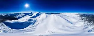 Magical panorama of a beautiful hill in the mountains covered by snow on the ski slope on a sunny day with a clear blue