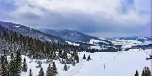 Magical winter panorama of beautiful snowy slopes at a ski resort in Europe on a sunny