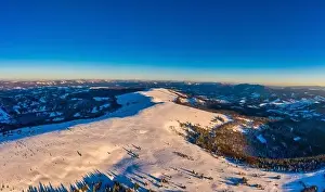 Magical winter panorama of beautiful snowy slopes at a ski resort in Europe on a sunny
