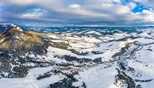 Magical winter panorama of beautiful snowy slopes at a ski resort in Europe on a sunny