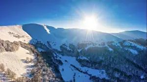Wintersport Prints: Magical winter panorama of beautiful snowy slopes at a ski resort in Europe on a sunny