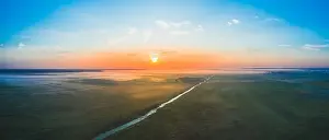 A magnificent panorama of the Belarusian field in the morning at dawn with fog and a river