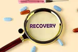 Pills Prints: A magnifying glass rests on a surface with the word RECOVERY displayed within its lens