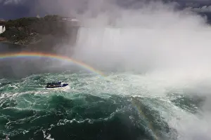 Thunderstorm Prints: Maid-of-the-mist tour boat in rainbow and incoming thunderstorm in Niagara falls
