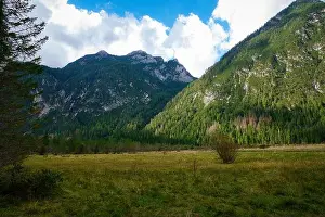 Lago Prints: Majestic mountains rise high above lush green fields