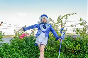 Asian Girl Prints: Makassar, Indonesia-July 9, 2024: an Asian woman cosplaying as Furina in the game Genshin Impact
