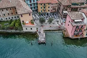 Malcesine, Italy - August 7, 2019: Aerial drone shot of village port in Malcesine