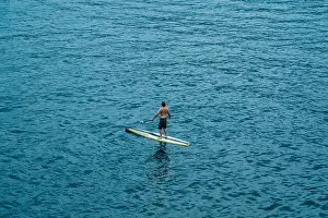 Lake Garda Prints: Malcesine, Italy - August 7, 2019: A man on surboard in Lake Garda