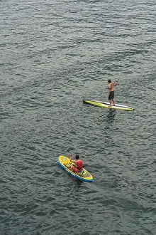 Lake Garda Prints: Malcesine, Italy - August 7, 2019: A man on surboard in Lake Garda