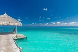 Maldives island beach. Tropical landscape of summer scenery, sea sand sky over jetty pier. Luxury travel vacation destination. Exotic beach landscape