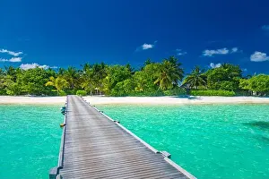Maldives island beach. Tropical landscape of summer scenery, sea sand sky over jetty pier. Luxury travel vacation destination. Exotic beach landscape