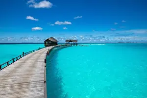 Maldives island beach. Tropical landscape of summer scenery, sea sand sky over jetty pier. Luxury travel vacation destination. Exotic beach landscape