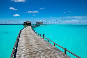 Maldives island beach. Tropical landscape of summer scenery, sea sand sky over jetty pier. Luxury travel vacation destination. Exotic beach landscape