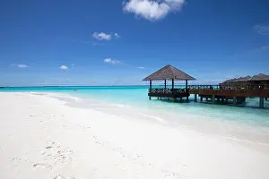 Maldives island beach. Tropical landscape of summer scenery, sea sand sky over jetty pier. Luxury travel vacation destination. Exotic beach landscape
