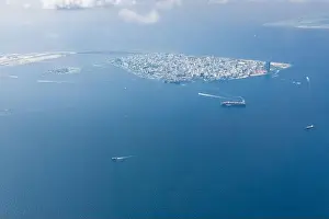 Maldives island capital island, Male. Hulhumale city island view from over the clouds. Aerial landscape in exotic travel destination