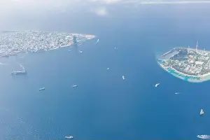 Maldives island capital island, Male. Hulhumale city island view from over the clouds. Aerial landscape in exotic travel destination