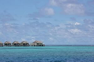 Images Dated 10th May 2018: Maldives island, luxury water villas resort and wooden pier. Beautiful sky and clouds