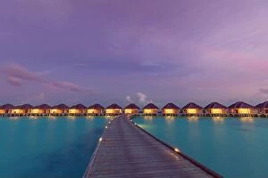 Images Dated 3rd August 2019: Maldives island sunset. Water bungalows resort at islands beach. Indian Ocean, Maldives