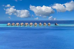 Maldives paradise island. Tropical aerial landscape, seascape with pier, water bungalows villas with amazing sea lagoon beach. Exotic aerial tourism